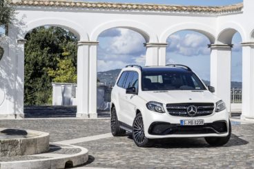 white mercedes GLS class in front of white columns