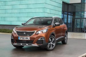 Peugeot 3008 burnt orange infront of blue building