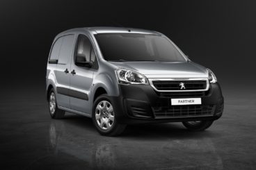 dark grey peugeot partner van isolated on dark background