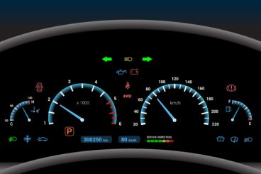 lit up car dashboard showing all the active things in the car and all safety system activated