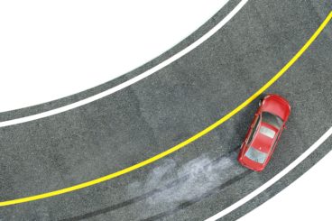 red car skidding around a corner isolated on white background