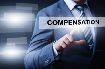 edited photo of a man in a suit pressing a floating button that says compensation