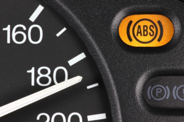 car dashboard with a yellow light showing the abs system lit up
