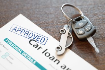 Approved car loan application with car keys