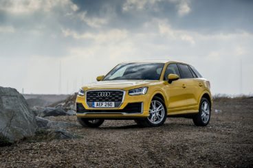 metallic yellow audi q2 in a beach setting
