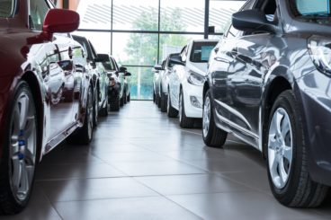 Car dealership with many cars aligned