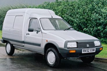 Silver Citroen C15 parked on a grass verge in the rain
