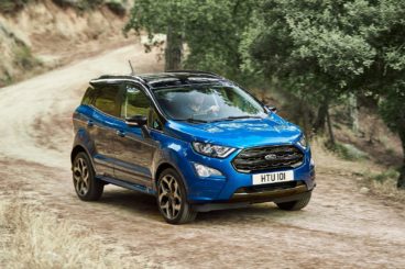 bright blue ford eco sport on dirt track in forest setting