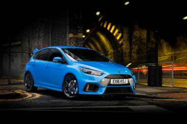 bright blue ford focus rs in dark city setting with a tunnel
