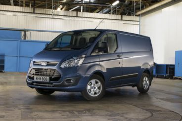 blue Ford Transit van parked in warehouse with blue and white walls in the background