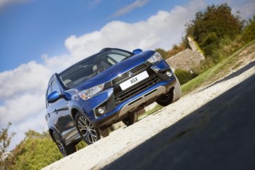 slated picture of a metallic blue Mitsubishi ASX estate parked on gravel driveway