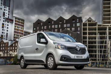 Silver Renault Traffic in front of buildings
