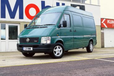 Green Volkswagen LT outside a Mobil warehouse
