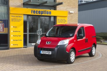 red peugeot bipper van parked outside office supplies shop