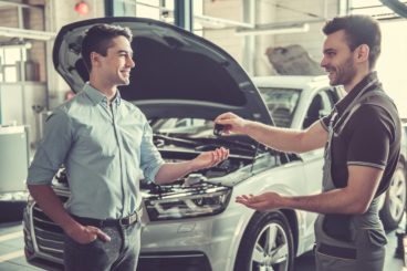 Man handing keys back at end of his lease agreement.