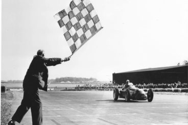 Alfa Romeo race car on a race track in black and white