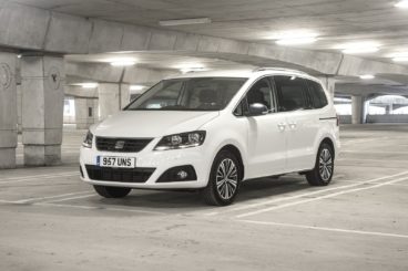 a white SEAT-Alhambra parked in well lit parking garage