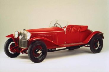 historic red Alfa Romeo convertible on a cream background