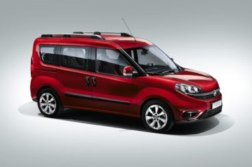 metallic red fiat doblo isolated on a grey/white background