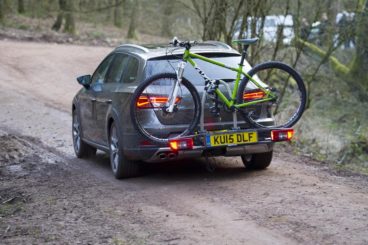 metallic seat leon x-perience diesel estate driving on muddy track with mountain bike on the back