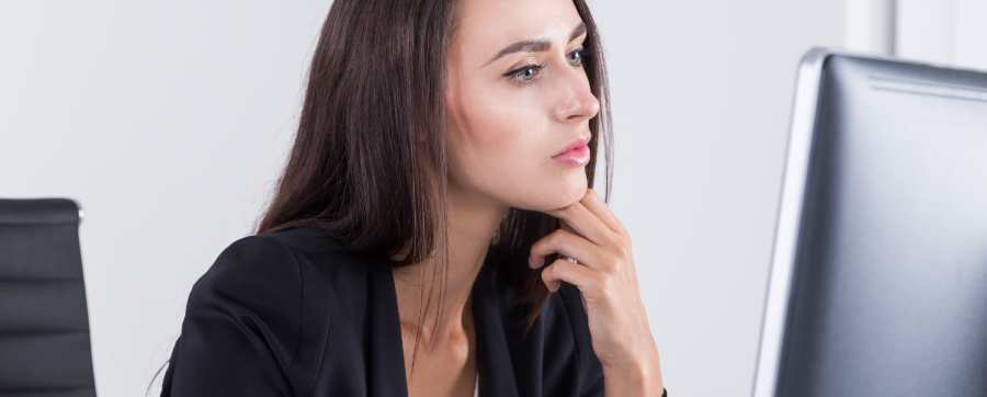 Business leasing - woman in business suit looking at her computer