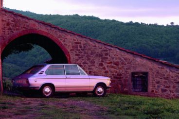 BMW 1802 parked next to a bridge