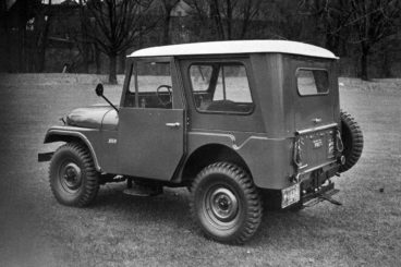 Jeep CJ5 parked on grass in black and white