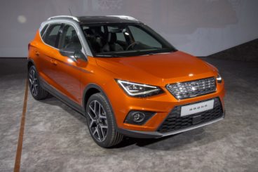 Orange SEAT Arona parked in a warehouse