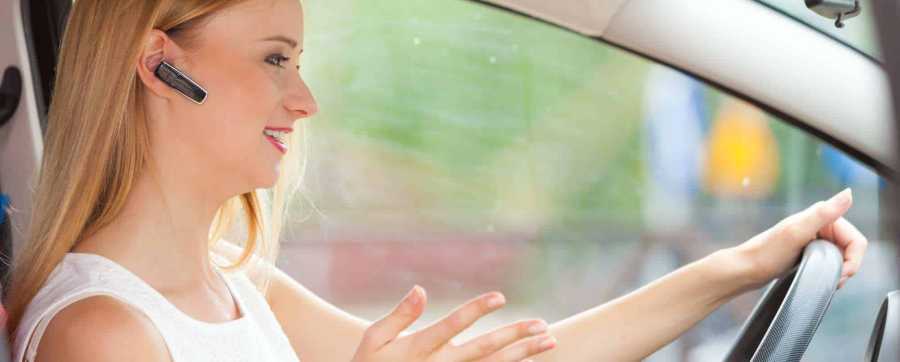 Woman talking on bluetooth in car