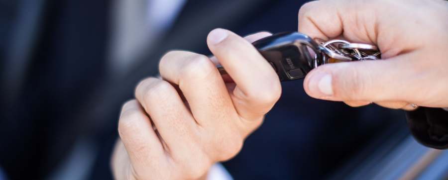 Man in suit being handed car keys