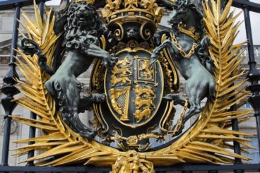 The royal crest on the gates of Buckingham Palace, London.