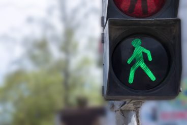 A traffic light with a green little man. Safety on the roads.