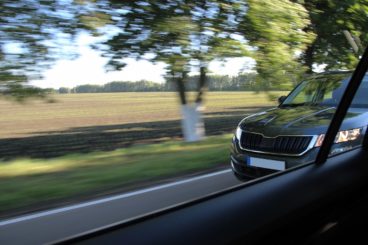 The car trying to overtake another car on the asphalt road