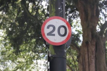 20mph sign with trees in the background