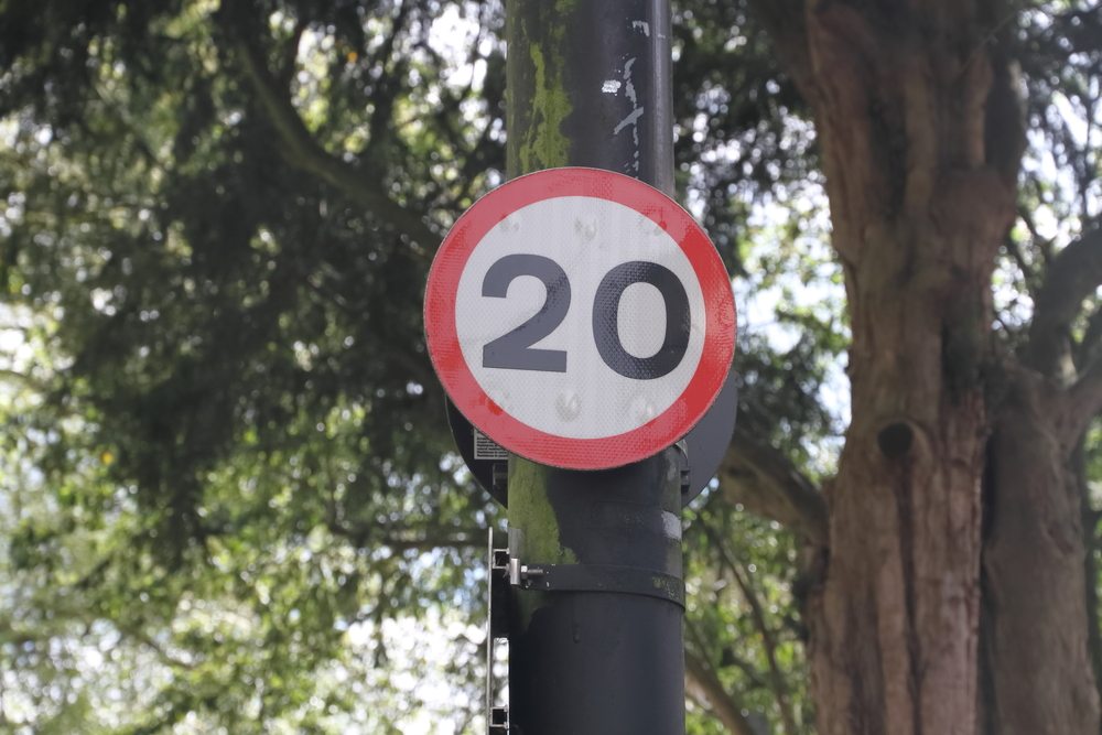 20mph sign with trees in the background