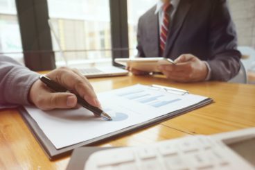 Financial inspector making report, calculating or checking balance.