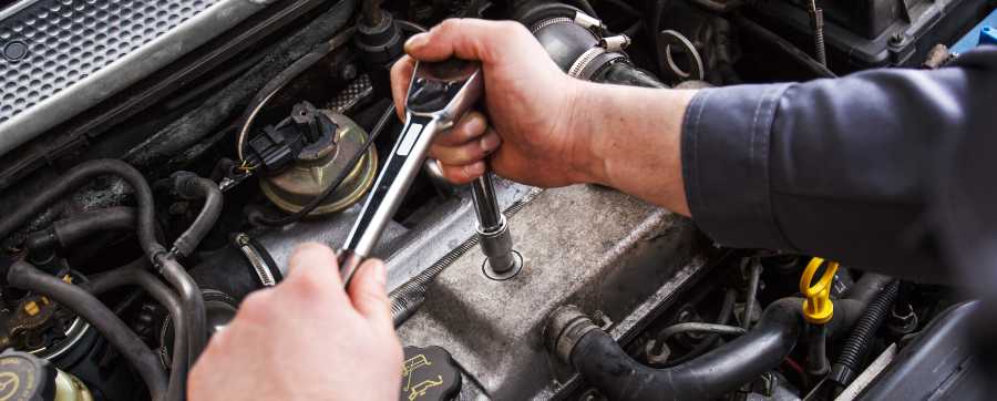 mechanic working on car engine