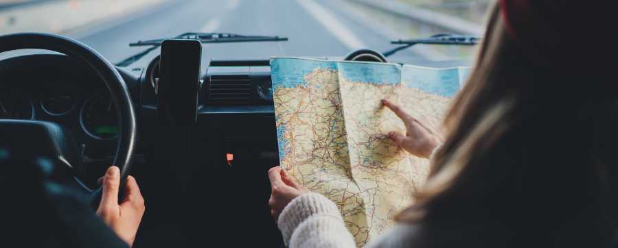 Passenger reading map in moving car