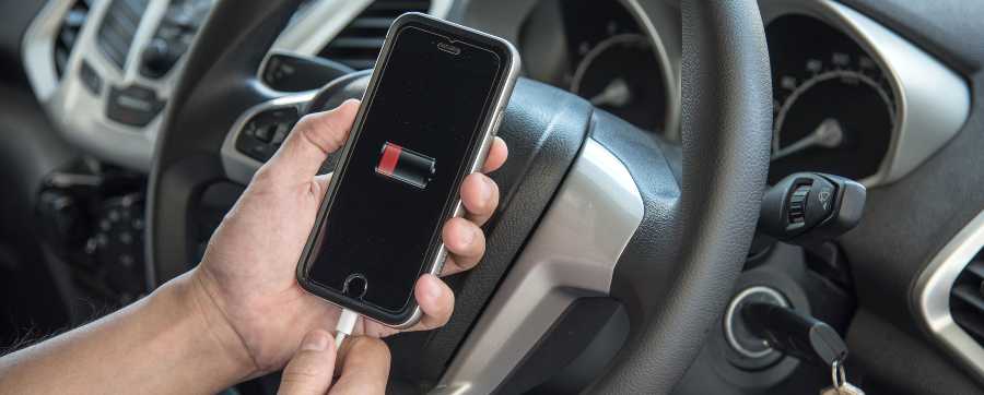 Person charging their mobile in their car