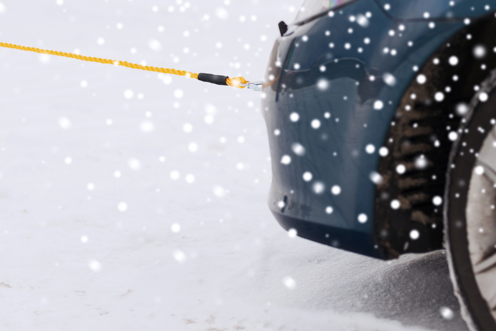 Car being towed by yellow tow rope