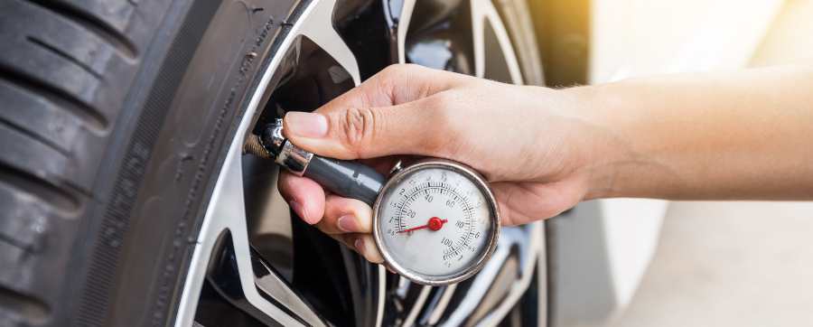 Person checking tyre pressure