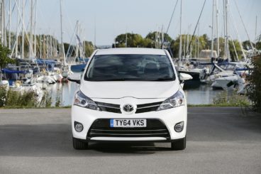 a white toyota verso estate parked on tarmac in a habour