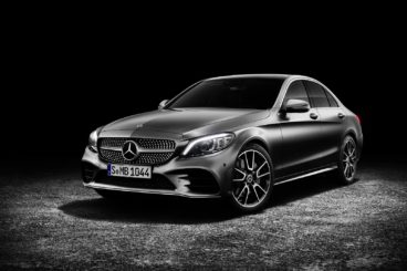 a metallic mercedes c class isolated on a black background