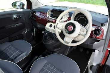 the black cloth and fiat 500 with the white steering wheel