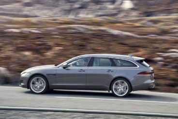 a grey Jaguar XF Sportbrake driving up steep grassy mountain