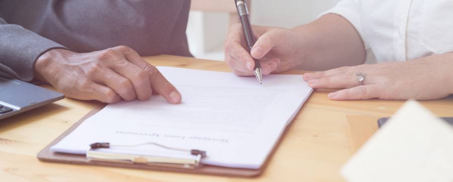 woman signing documents