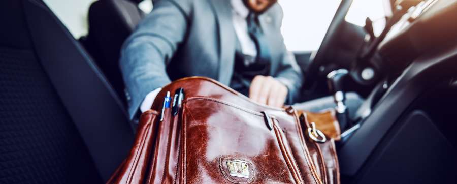 Man looking through a briefcase in his car