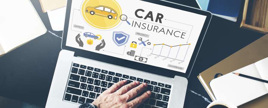 Person searching for car insurance on a laptop