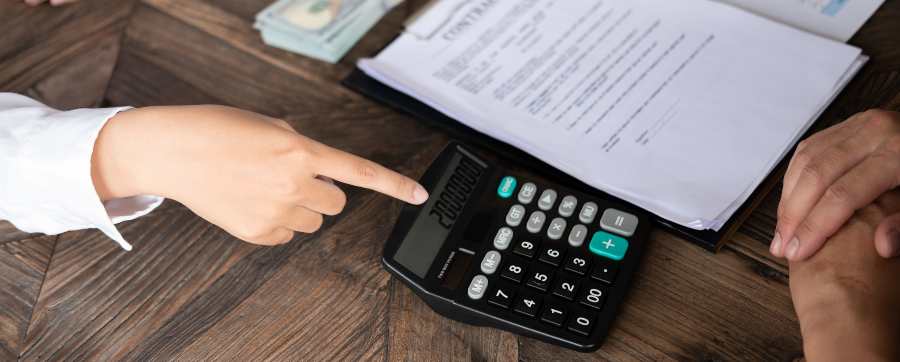 Person showing sum on calculator to someone else - company car tax