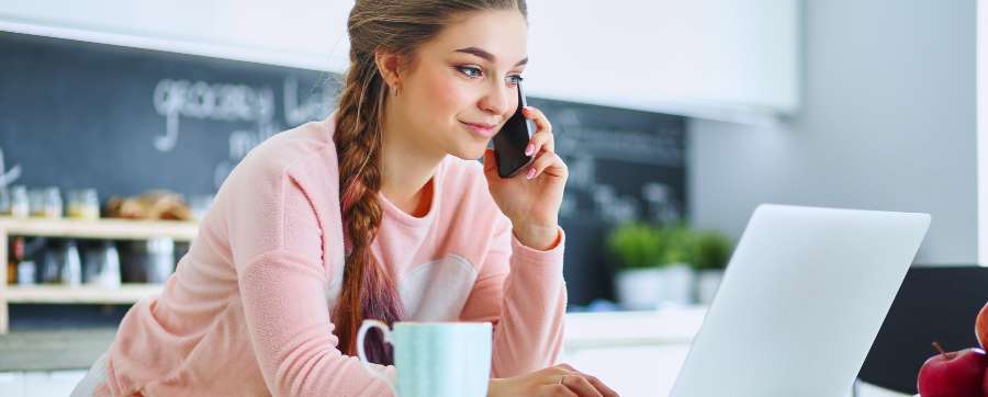 Woman on telephone using computer